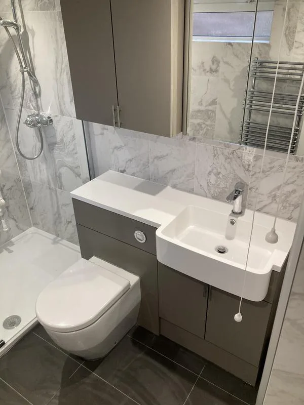 Bathroom with combination vanity unit, wall-hung toilet and shower