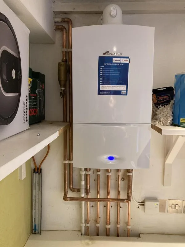 Wall-mounted boiler with tidy copper pipework beneath