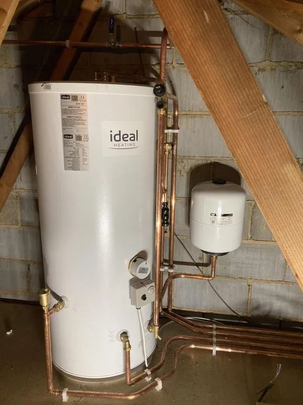 Hot water cylinder and expansion vessel installed in a loft space